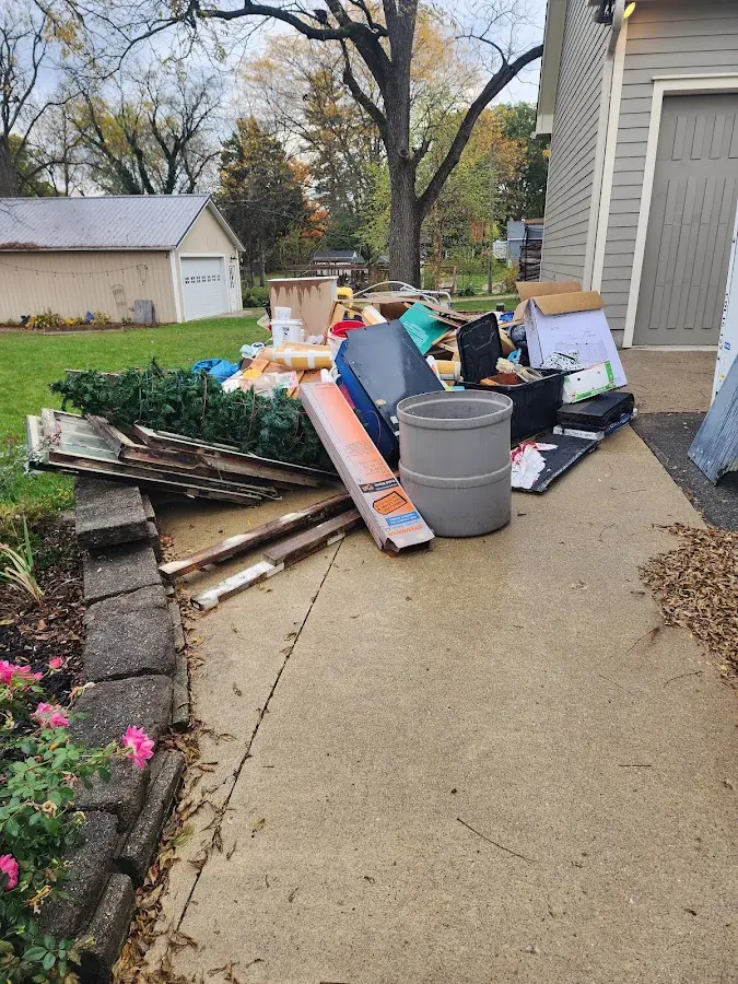 Dumpster being loaded with debris for Roofing Dumpster Rental in Marianna
